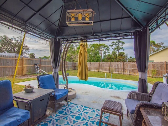 view of swimming pool with a patio area and a gazebo