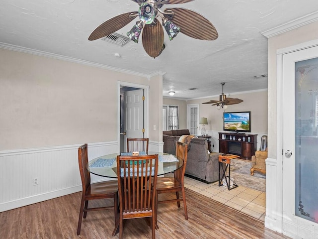 dining room featuring ceiling fan, light hardwood / wood-style flooring, and ornamental molding