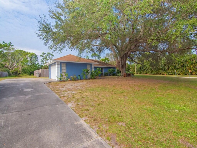 view of front of home with a garage and a front yard