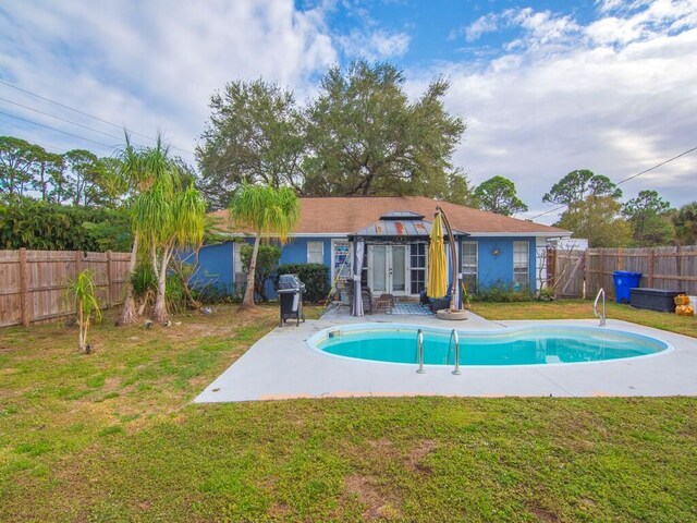 view of pool with a lawn, a gazebo, a patio, and area for grilling