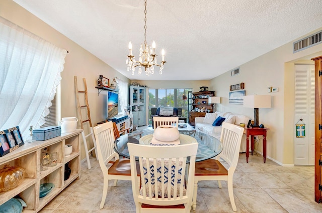 dining area featuring a chandelier, a textured ceiling, light tile patterned flooring, and visible vents