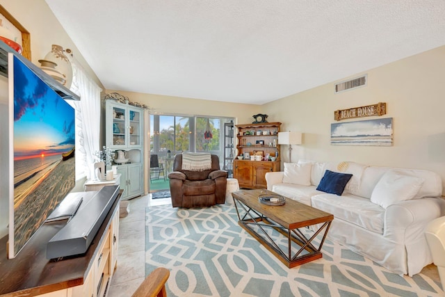 living room with visible vents and a textured ceiling