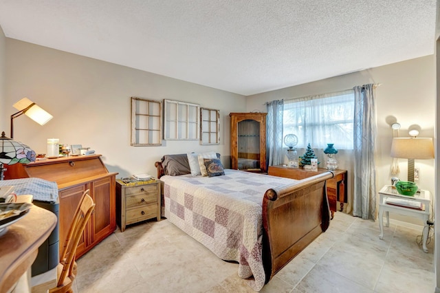 bedroom featuring a textured ceiling and light tile patterned floors