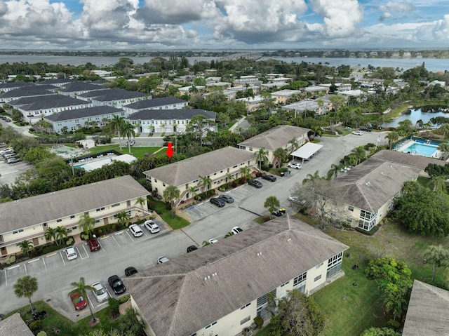 drone / aerial view with a residential view and a water view