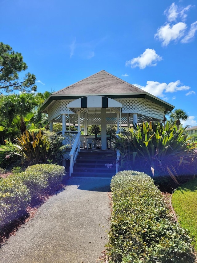 view of front of property featuring a gazebo and a shingled roof