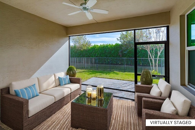 sunroom featuring a wealth of natural light and ceiling fan