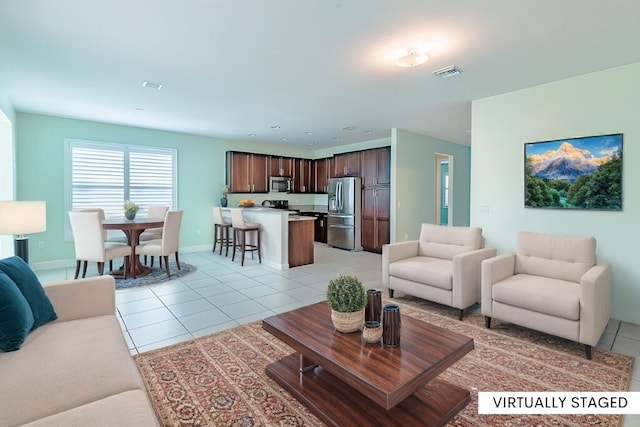 living area featuring visible vents, baseboards, and light tile patterned flooring