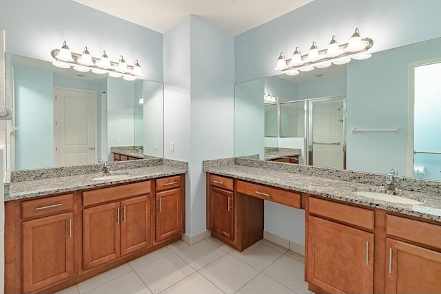 bathroom with vanity, tile patterned flooring, and a shower with door