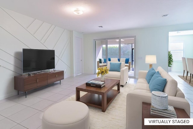 living area featuring light tile patterned floors, baseboards, and visible vents