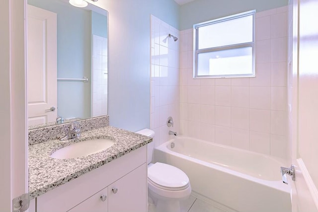 full bathroom with tile patterned floors, toilet, vanity, and tiled shower / bath