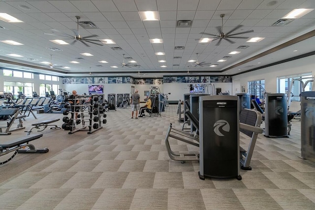 workout area with a paneled ceiling and light carpet