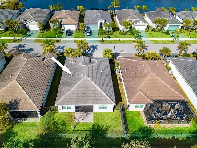 aerial view featuring a residential view and a water view