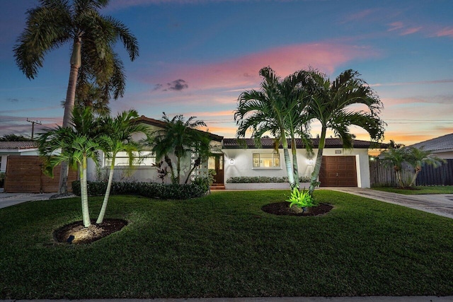 view of front facade featuring a garage and a lawn