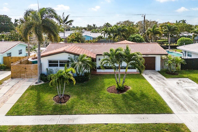 view of front of house with a garage and a front yard