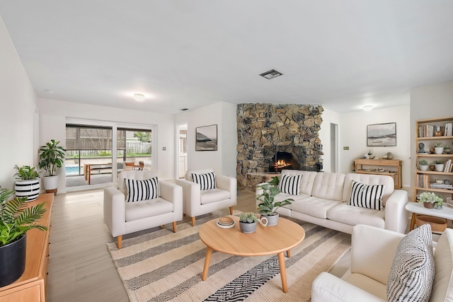 living room with light hardwood / wood-style floors and a fireplace