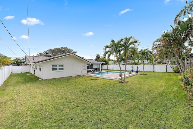 view of yard featuring a fenced in pool and a sunroom