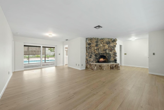 unfurnished living room with light hardwood / wood-style floors and a fireplace