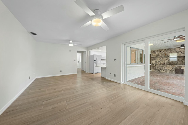 unfurnished living room with ceiling fan and hardwood / wood-style floors