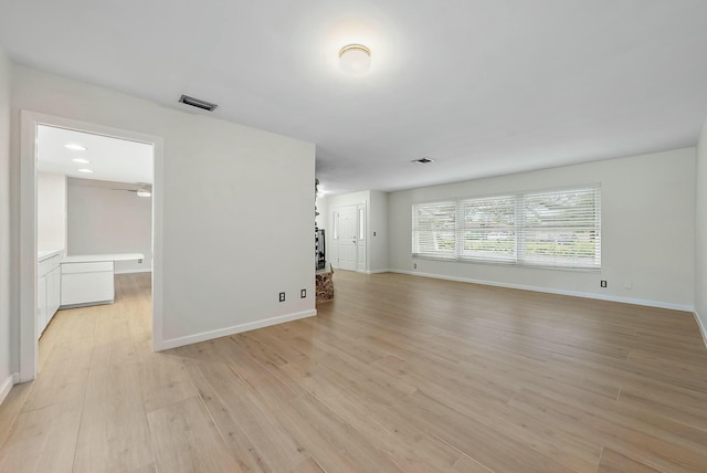 unfurnished living room with ceiling fan and light wood-type flooring