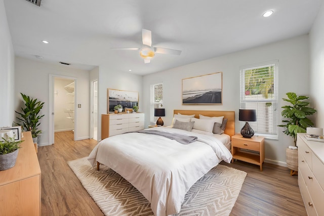 bedroom with ceiling fan and light hardwood / wood-style flooring