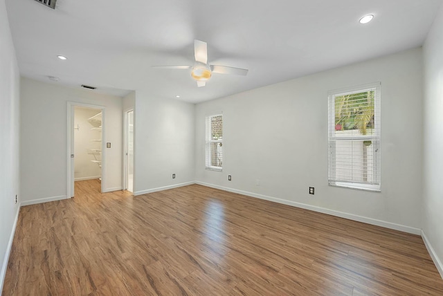 empty room featuring ceiling fan and light hardwood / wood-style flooring