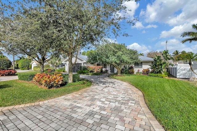 view of property hidden behind natural elements featuring a front yard