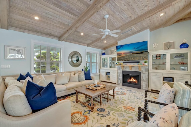 living room with wooden ceiling, ceiling fan, a fireplace, and lofted ceiling with beams