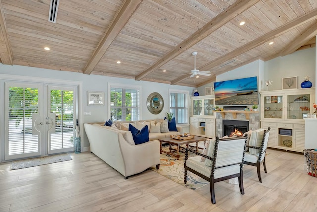 living room with beam ceiling, french doors, a tile fireplace, and wooden ceiling