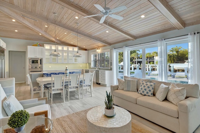 living room featuring light hardwood / wood-style floors, ceiling fan, plenty of natural light, and wood ceiling