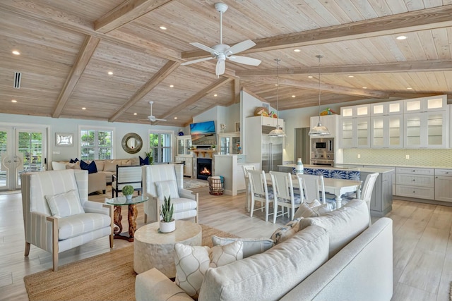 living room featuring ceiling fan, light hardwood / wood-style flooring, beam ceiling, and wood ceiling