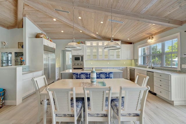 dining area with wooden ceiling, light hardwood / wood-style flooring, and beamed ceiling