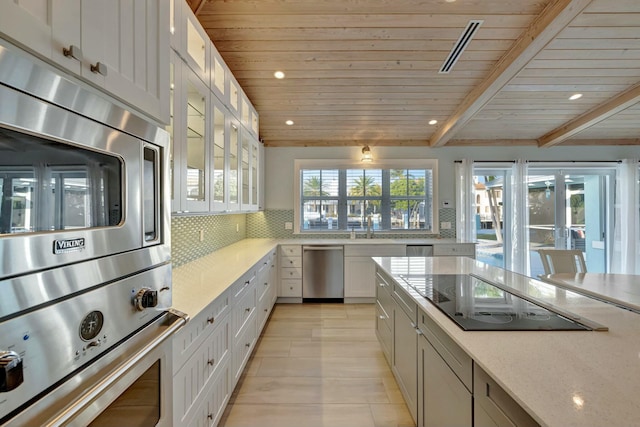 kitchen with wood ceiling, white cabinetry, stainless steel appliances, tasteful backsplash, and beam ceiling