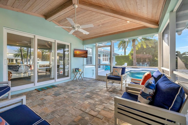 sunroom with ceiling fan, lofted ceiling with beams, and wooden ceiling