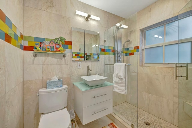 bathroom featuring toilet, vanity, and an enclosed shower