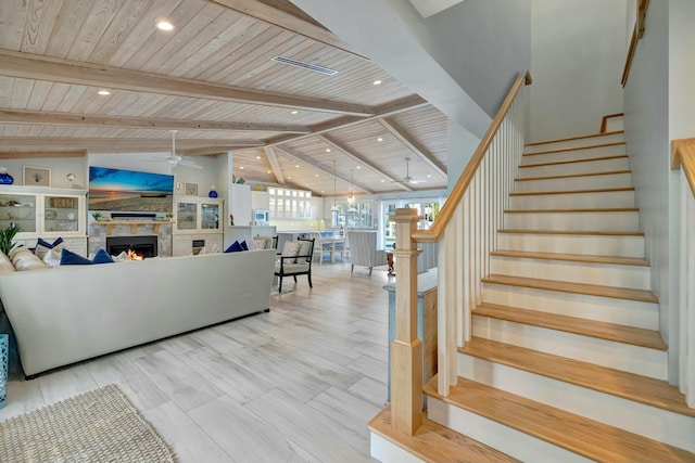 interior space with ceiling fan, vaulted ceiling with beams, and wooden ceiling