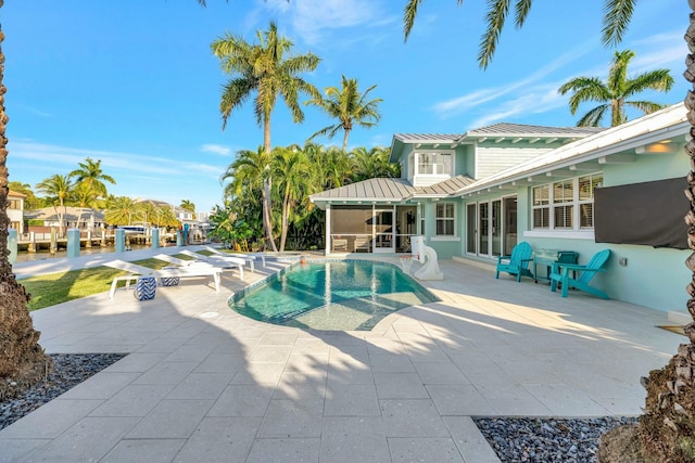 view of swimming pool featuring a sunroom and a patio