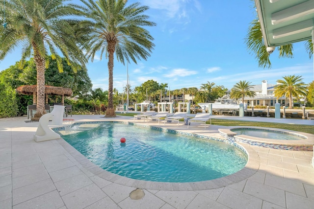 view of pool with an in ground hot tub and a patio area