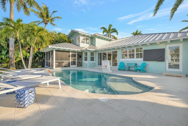 rear view of house with a patio and a sunroom