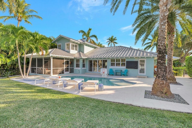 back of house with a yard, a patio, a fenced in pool, and a sunroom