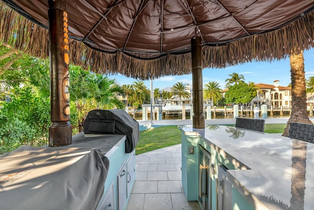 view of patio featuring a gazebo, exterior bar, and a grill