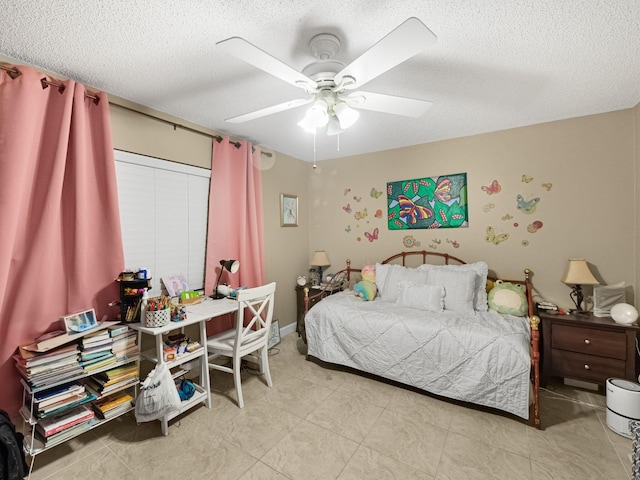 bedroom with a textured ceiling and ceiling fan