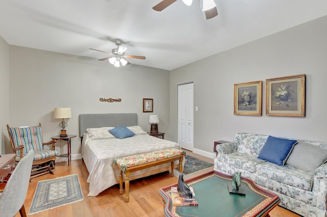 bedroom featuring ceiling fan, a closet, and wood-type flooring