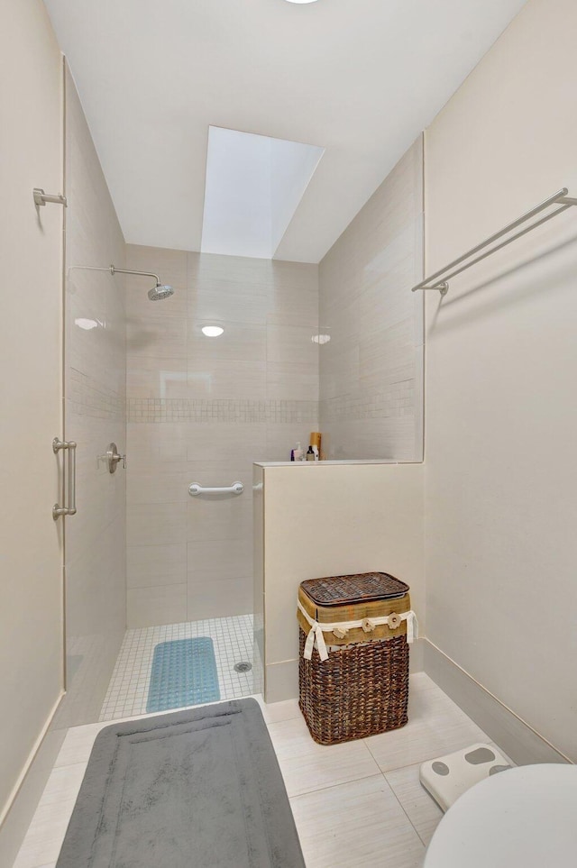 bathroom with toilet, tile patterned floors, and a shower with door