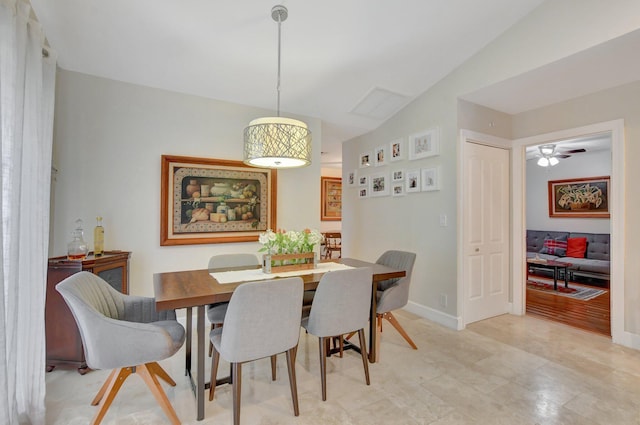 dining room with ceiling fan and vaulted ceiling