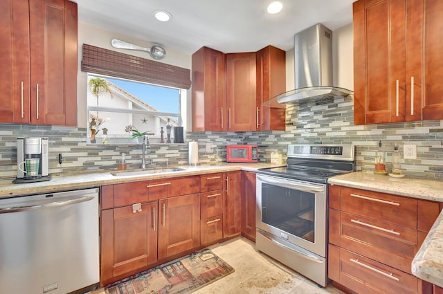 kitchen with tasteful backsplash, sink, light stone countertops, appliances with stainless steel finishes, and wall chimney exhaust hood