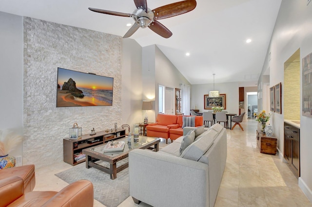 living room with ceiling fan and high vaulted ceiling