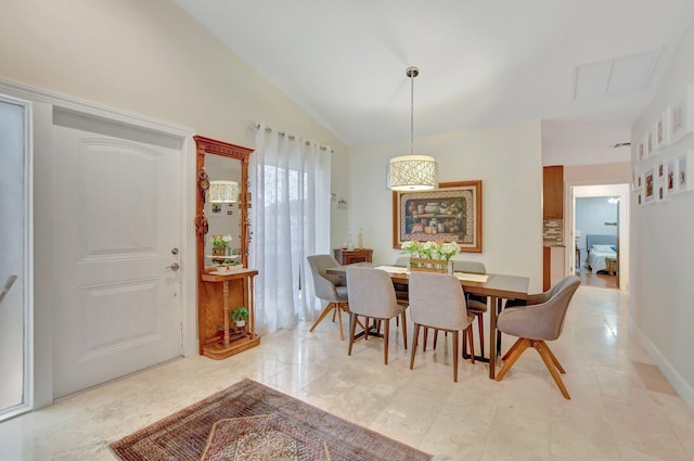 dining space featuring vaulted ceiling