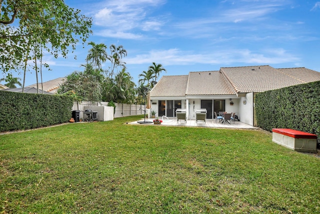 back of property featuring a yard and a patio