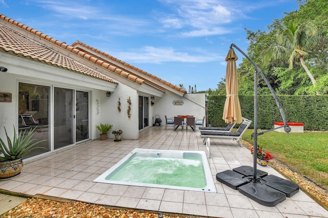 view of pool with a hot tub and a patio