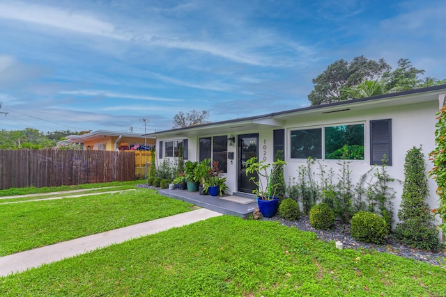 single story home featuring a front lawn